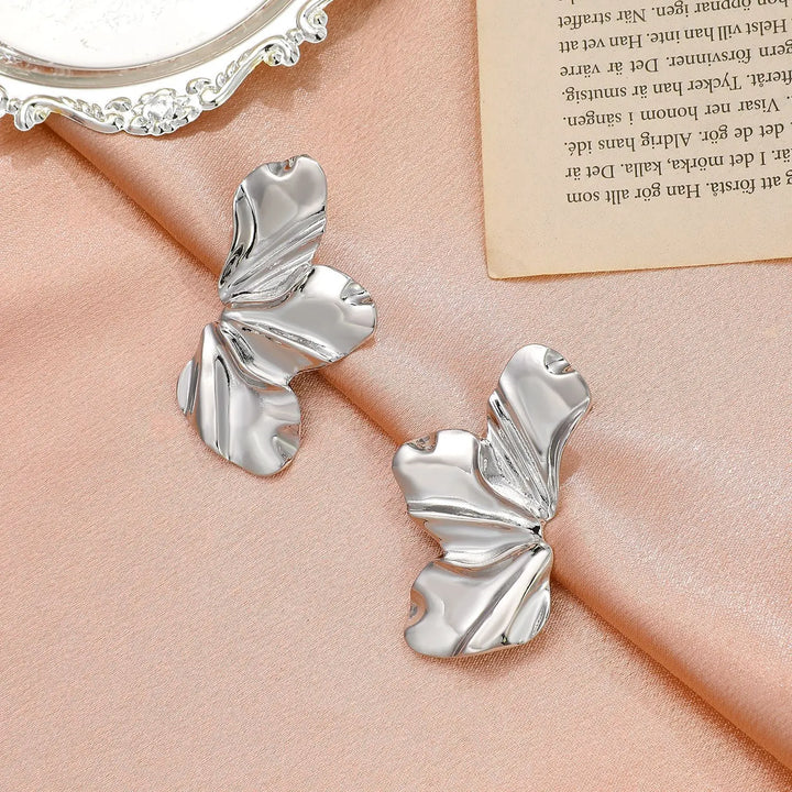Golden floral stud earrings for women, featuring an elegant petal design.