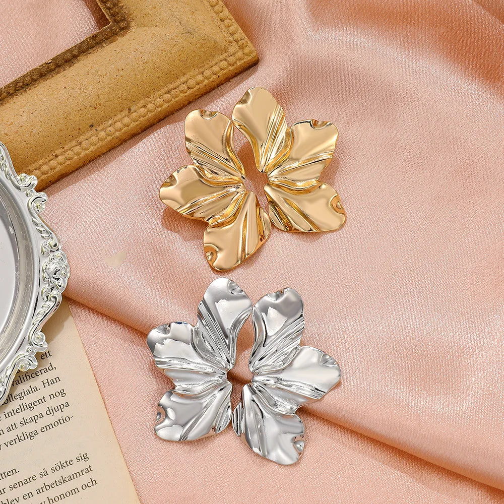 Elegant women's gold petal stud earrings, a sophisticated floral jewelry piece.