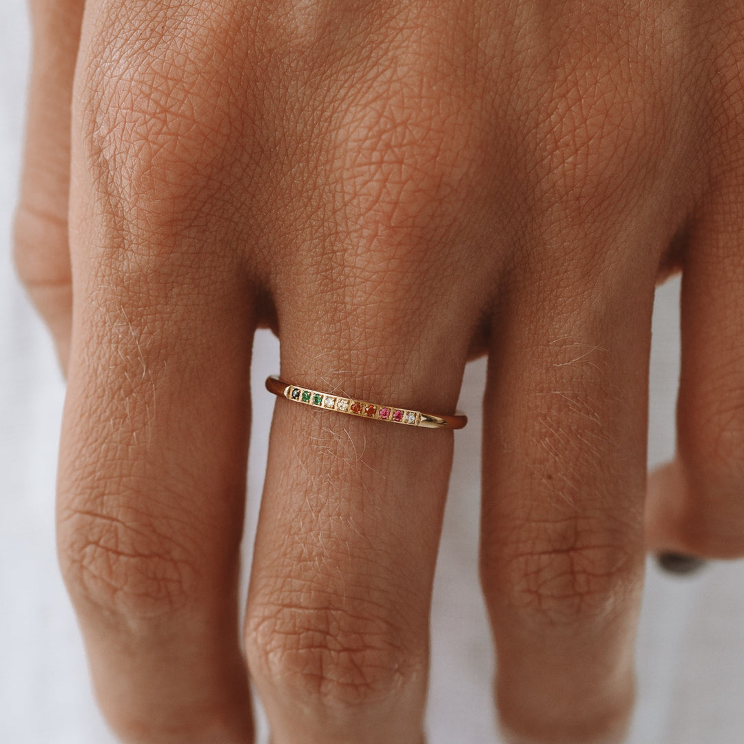 Women's golden ring with vibrant colorful gemstone accents, a beautiful fashion statement.