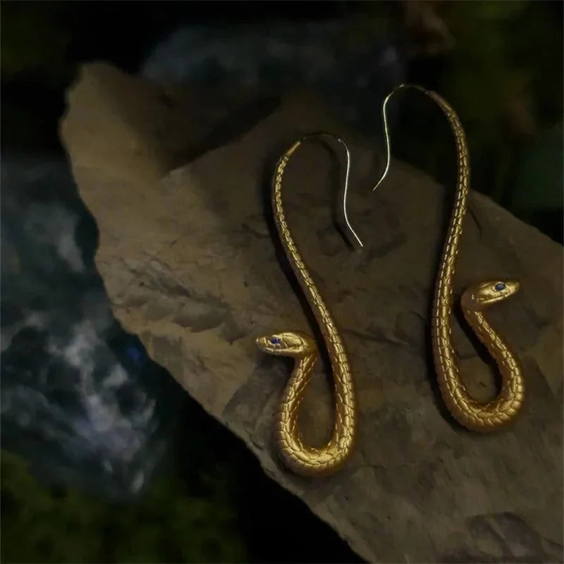 Elegant women's gold snake drop earrings, animal-themed fashion jewelry for a chic and unique look.