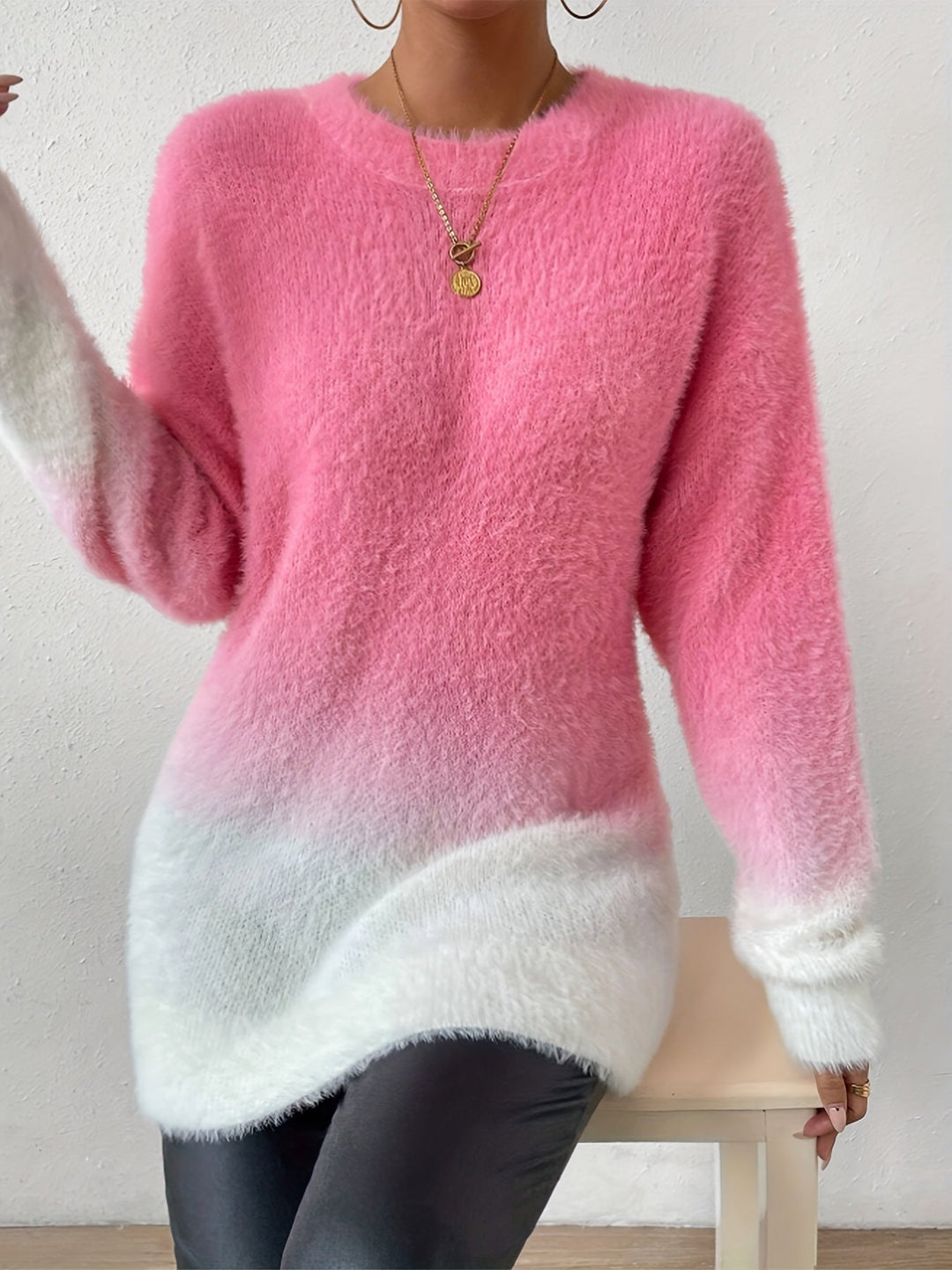 Women's cozy pink fuzzy crew neck sweater with a graduated color design. A stylish and warm top for winter.