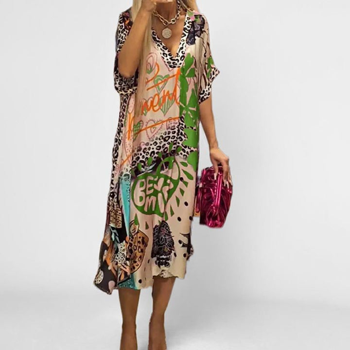 Relaxed fit women's tunic swing dress, graphic print, V-neck, short sleeve, perfect for casual summer fashion.