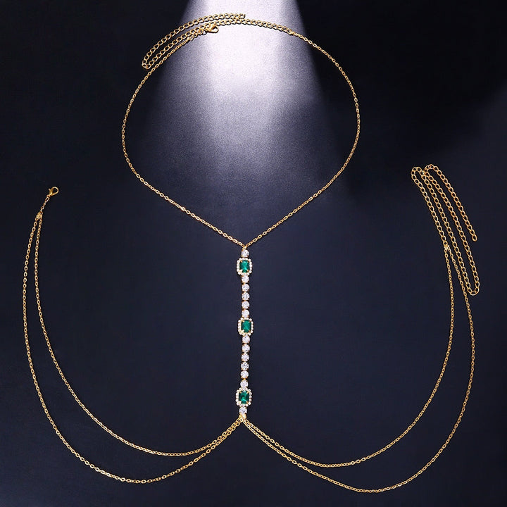 Silver-tone green crystal body chain, a chic women's statement piece. Glamorous rhinestone chest jewelry accessory.