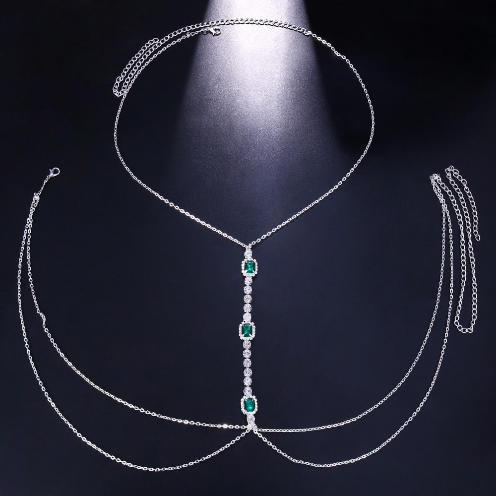 Fashionable green crystal chest chain for women, a brilliant body jewelry accessory. Sparkling rhinestone design.