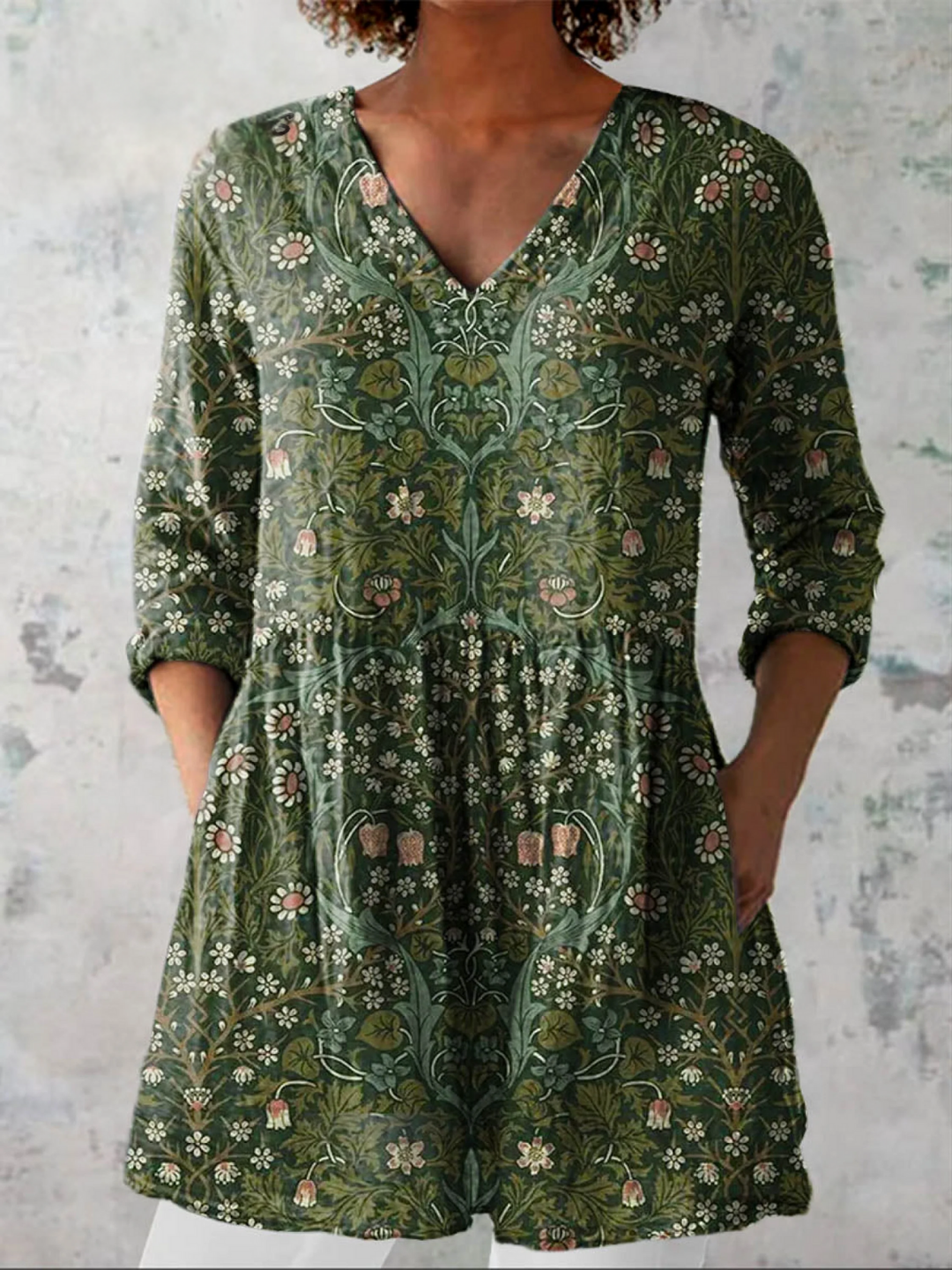 Women's green relaxed V-neck tunic top with three-quarter sleeves. Comfortable, loose-fit casual blouse for daily wear.