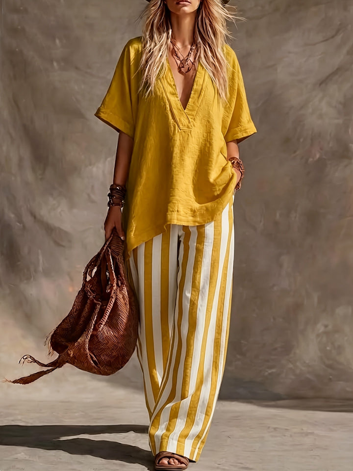 Coordinated V-neck short sleeve top & high-waisted striped wide leg pants in green & yellow for women.