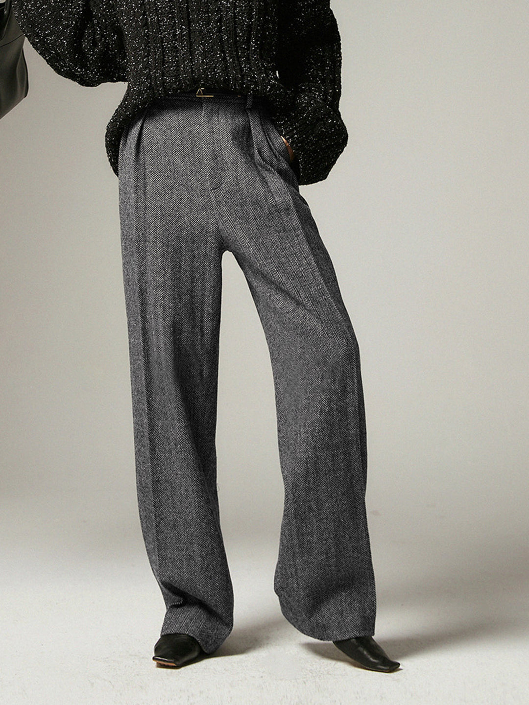 Stylish grey pleated wide-leg trousers for women, versatile for fashion or professional office wear. Comfortable & modern.