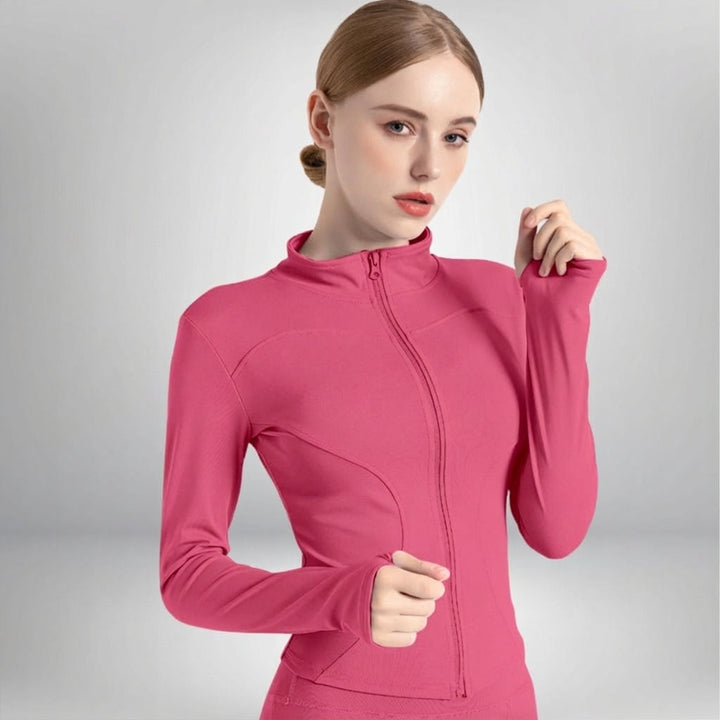 Woman warming up in a black Hailey breathable training jacket, suitable for yoga and fitness