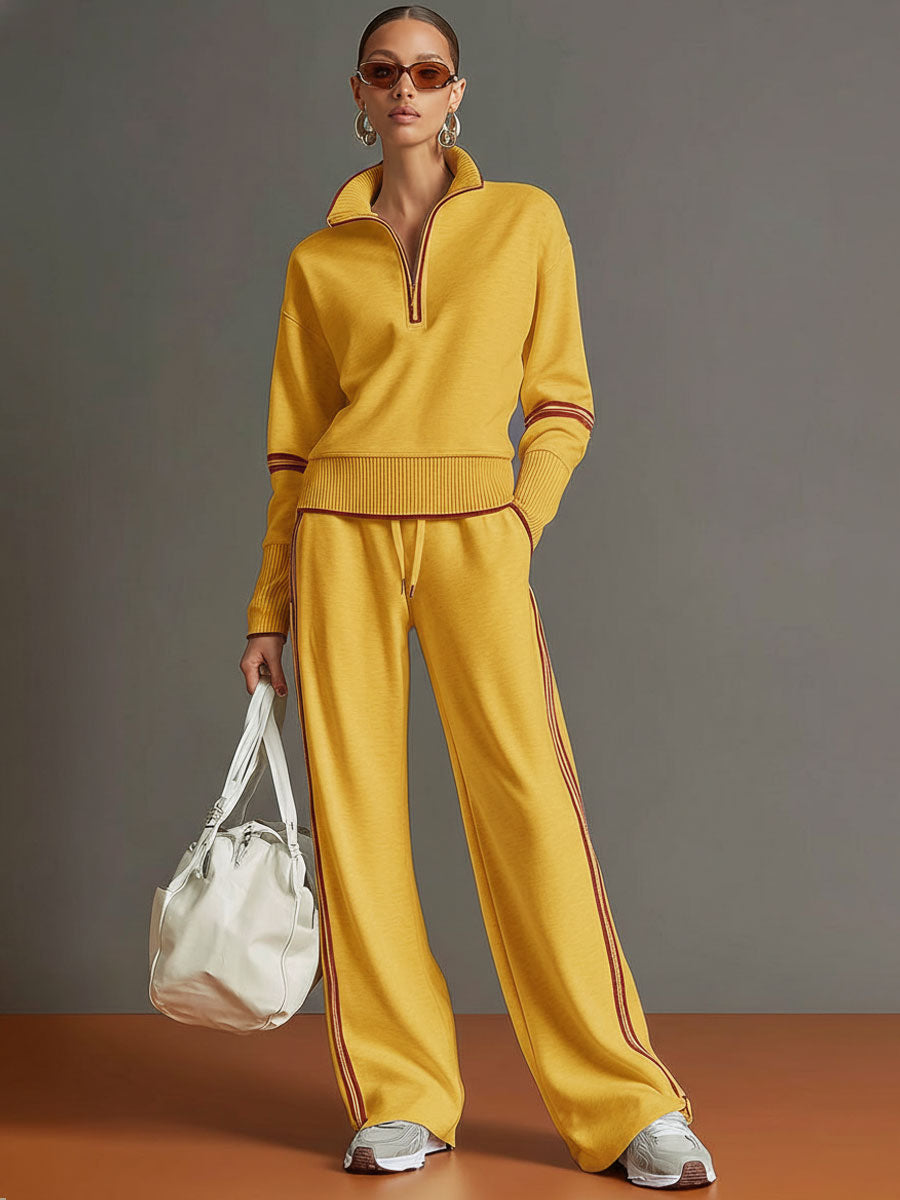 Front view of a woman wearing the modern half-zip sweatshirt and flowing wide-leg trouser set.