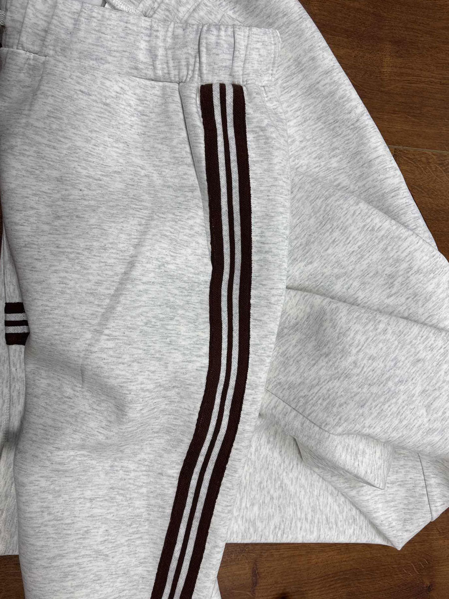 Trendy women's clothing set with a half-zip detail sweatshirt and fashionable wide-leg silhouette trousers.