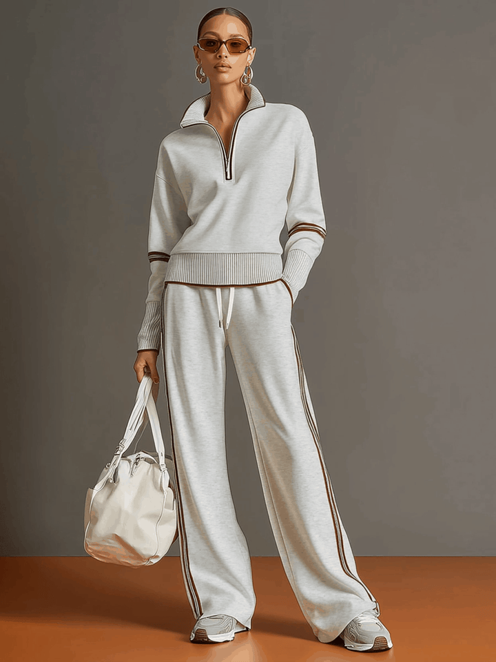 Stylish women's two-piece matching set: a casual half-zip sweatshirt and relaxed wide-leg trousers.