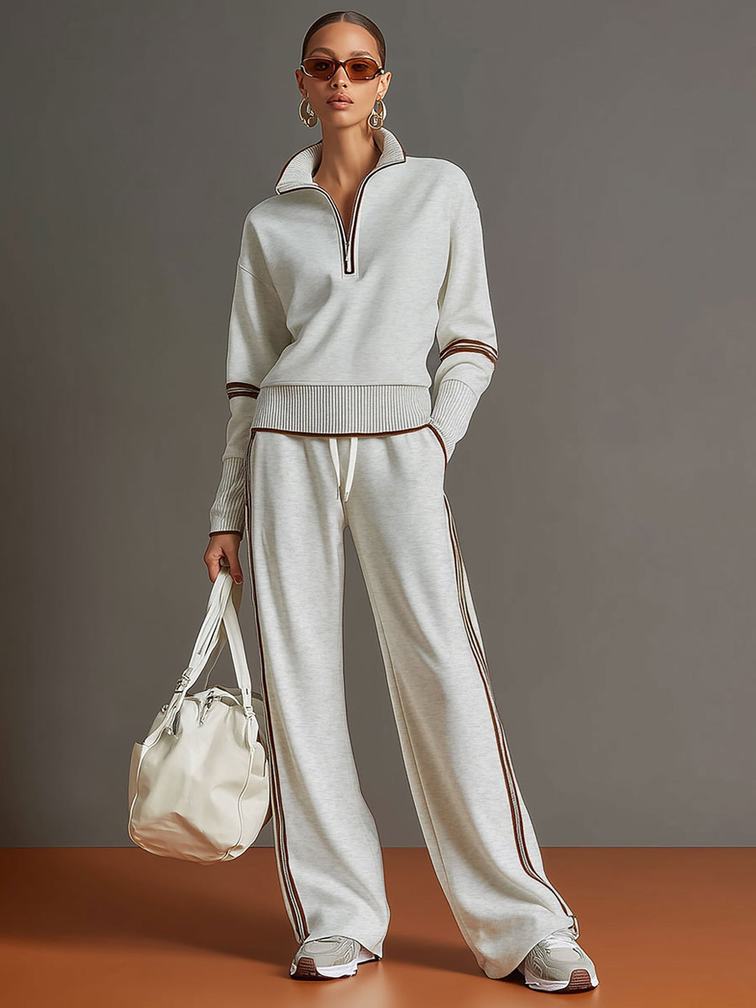 Fashionable women's co-ord set with a cozy half-zip sweatshirt and elegant wide-leg trousers.