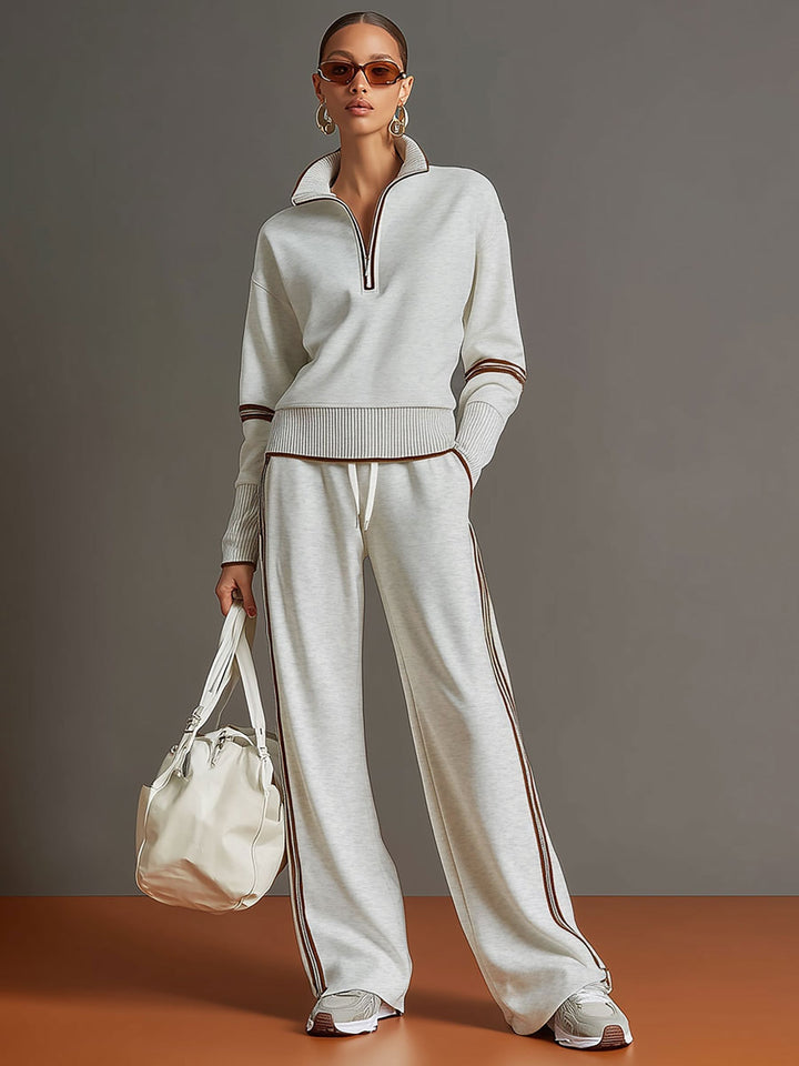 Fashionable women's co-ord set with a cozy half-zip sweatshirt and elegant wide-leg trousers.