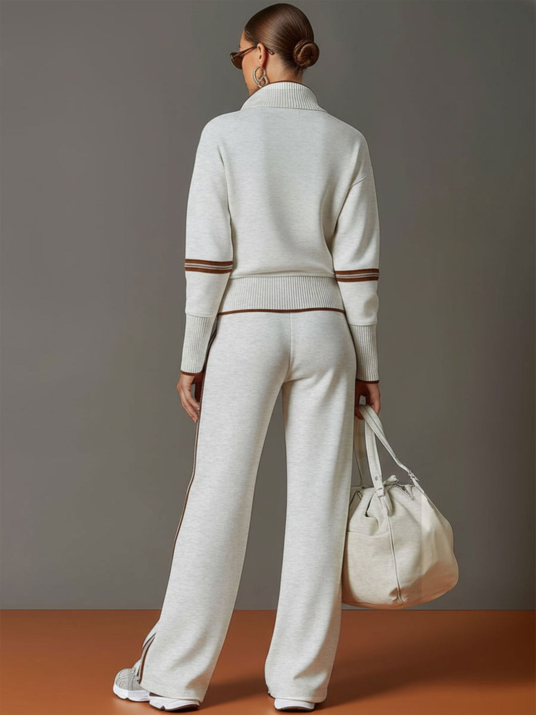 Close-up of women's half-zip sweatshirt, showing ribbed cuffs and soft fabric detail, casual wear.