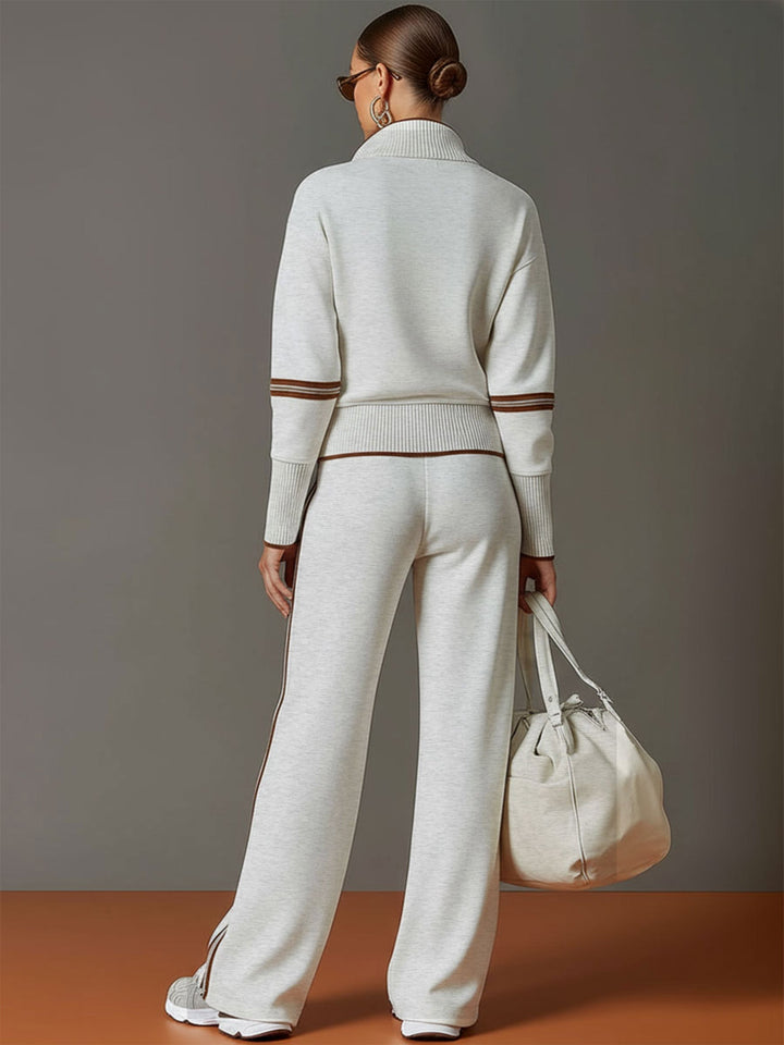 Close-up of women's half-zip sweatshirt, showing ribbed cuffs and soft fabric detail, casual wear.