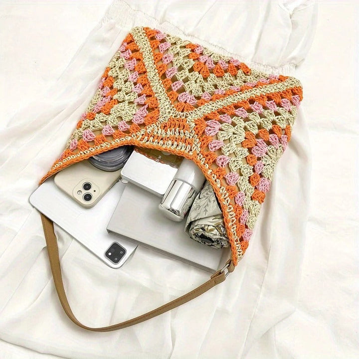 Fashionable women's hand-crocheted tote, vibrant boho style, perfect summer shoulder bag.