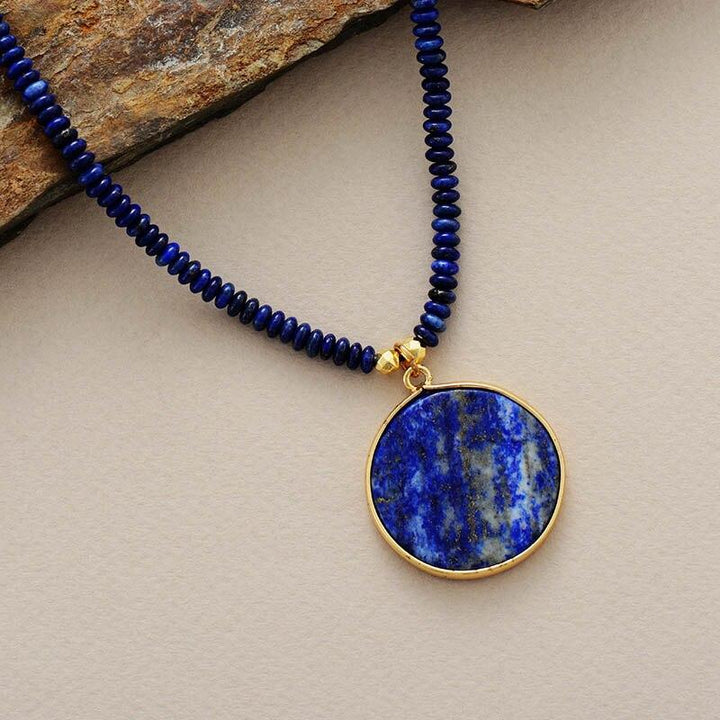 Elegant women's round lapis lazuli pendant necklace, a unique handcrafted gemstone jewelry gift.