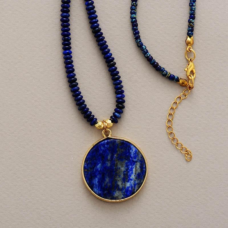 Spiritual women's round lapis lazuli gemstone pendant for meditation, a handcrafted healing stone necklace.