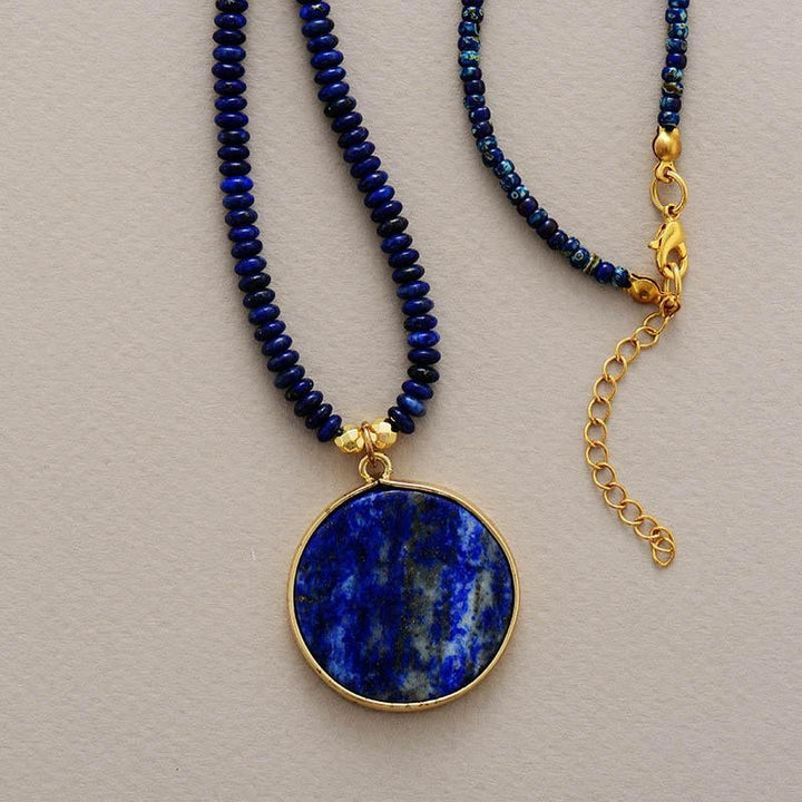 Spiritual women's round lapis lazuli gemstone pendant for meditation, a handcrafted healing stone necklace.