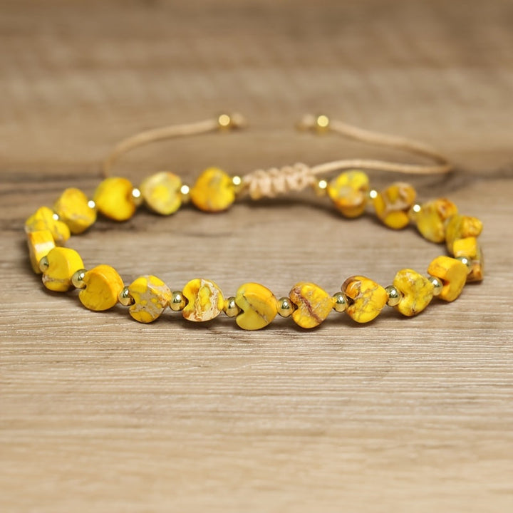 Women's heart-shaped gemstone bead bracelet with natural stones and elegant gold accents.