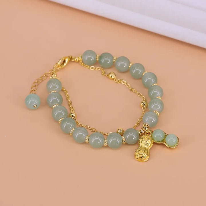 Fine women's Hetian Jade bracelet featuring a delicate gold accent, a luxurious and adjustable gemstone jewelry piece.