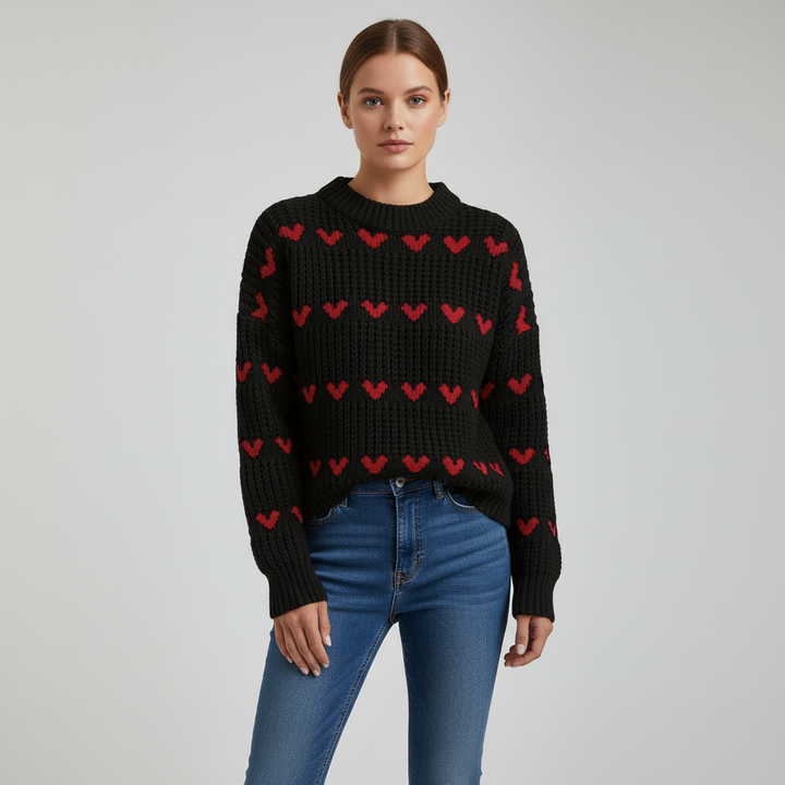 Detail of the high collar and heart pattern on a women's acrylic knit winter sweater