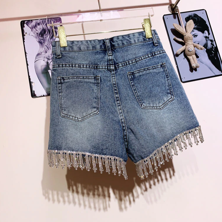 Stylish women's blue high-rise shorts, a versatile bottom for summer days and fashion-forward warm weather looks.