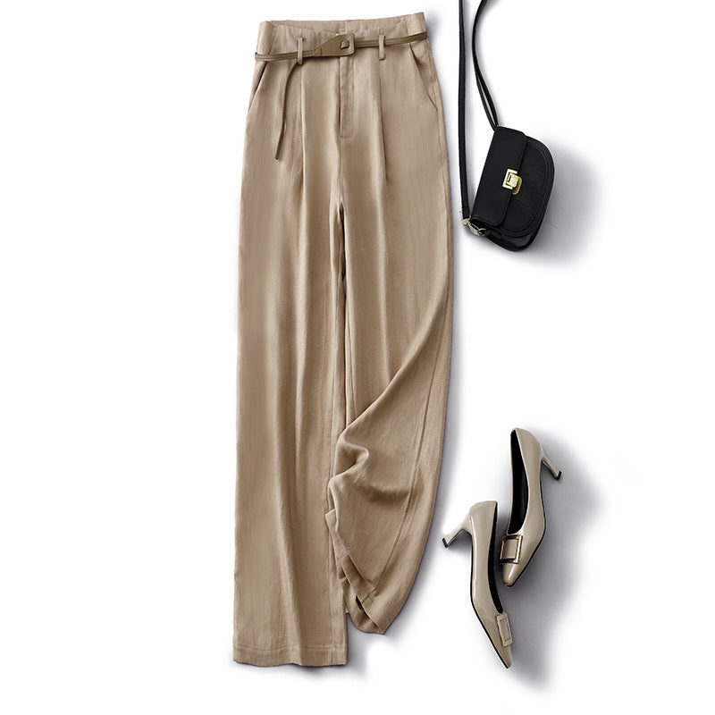 Model in cream high-rise flowy trousers, showcasing their elegant drape and comfortable fit.