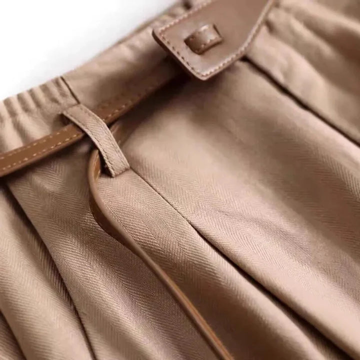 Woman wearing high-rise flowy trousers, demonstrating effortless style, comfort, and elegant fashion.