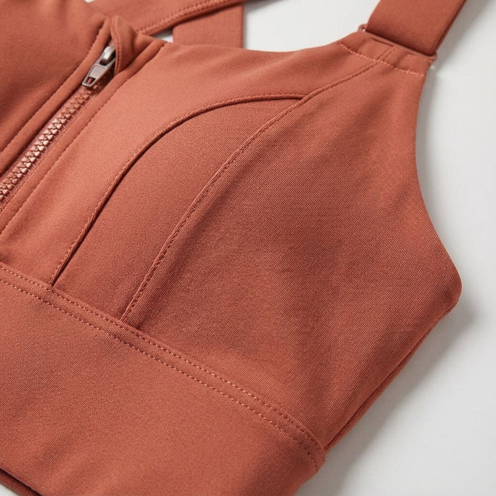 Close-up of the front zipper on a women's quick-dry sports bra, highlighting adjustable features.