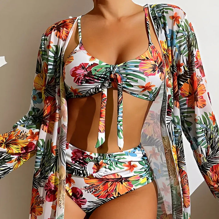 Three-piece women's swimwear: high-waisted floral bikini top, bottom, and sheer cover-up.