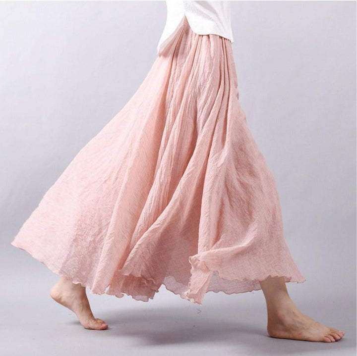 Woman walking in a flowing high-waist A-line maxi skirt, showcasing its elegant bohemian style for summer comfort.