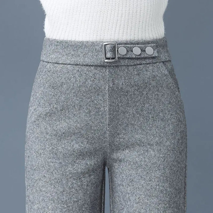 Women's high-waist Astoria pants with a sophisticated statement belt. Tailored for office or elegant casual wear.
