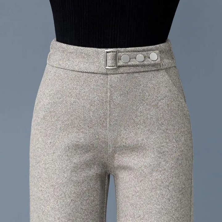 Tailored herringbone high-waist women's pants featuring elegant button detail. Perfect for formal or business attire.