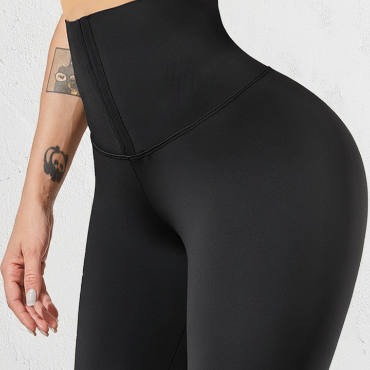 Black activewear leggings with corset detail, designed for women's fitness and athletic pursuits.