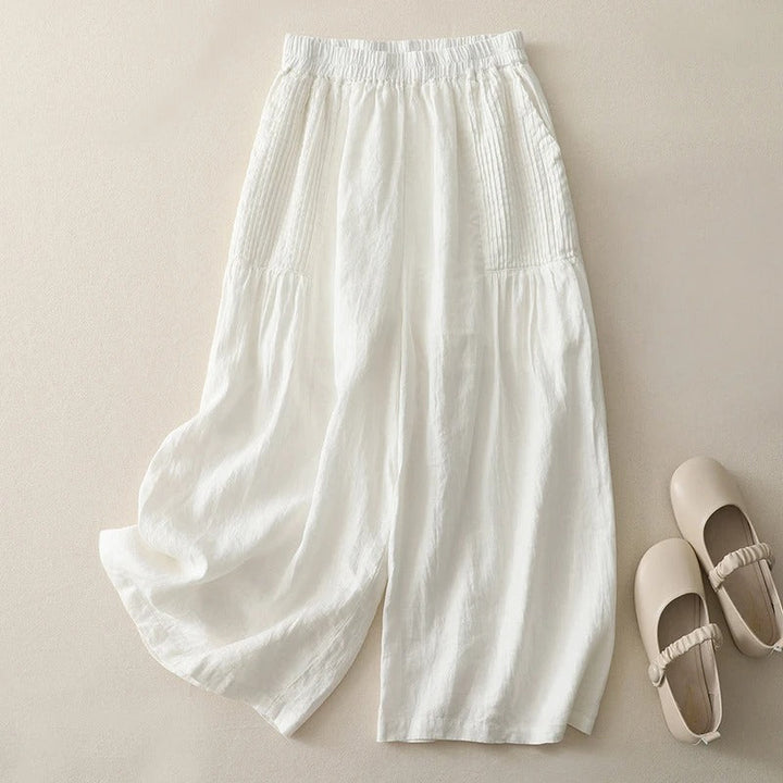 Women's high-waist flowy wide-leg trousers in cream. Elegant, comfortable, & versatile for effortless style.