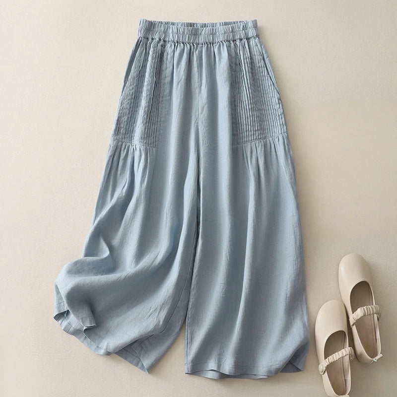 Elegant light blue wide-leg trousers for women. High-waist, flowy design ensures comfort & versatile styling.