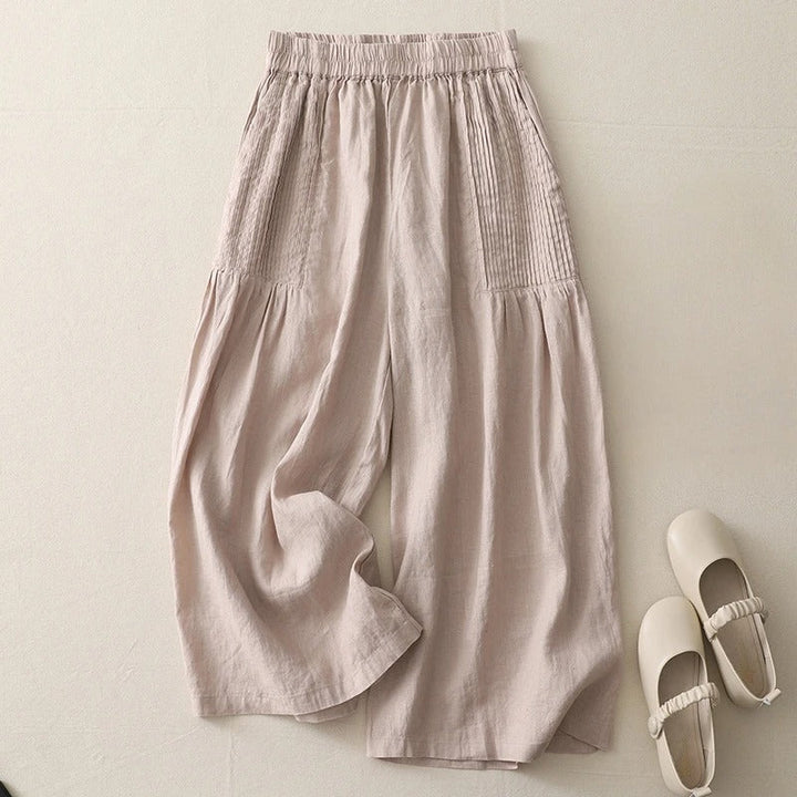 Beige women's comfortable wide-leg trousers. Flowy high-waist pants perfect for casual or stylish occasions.