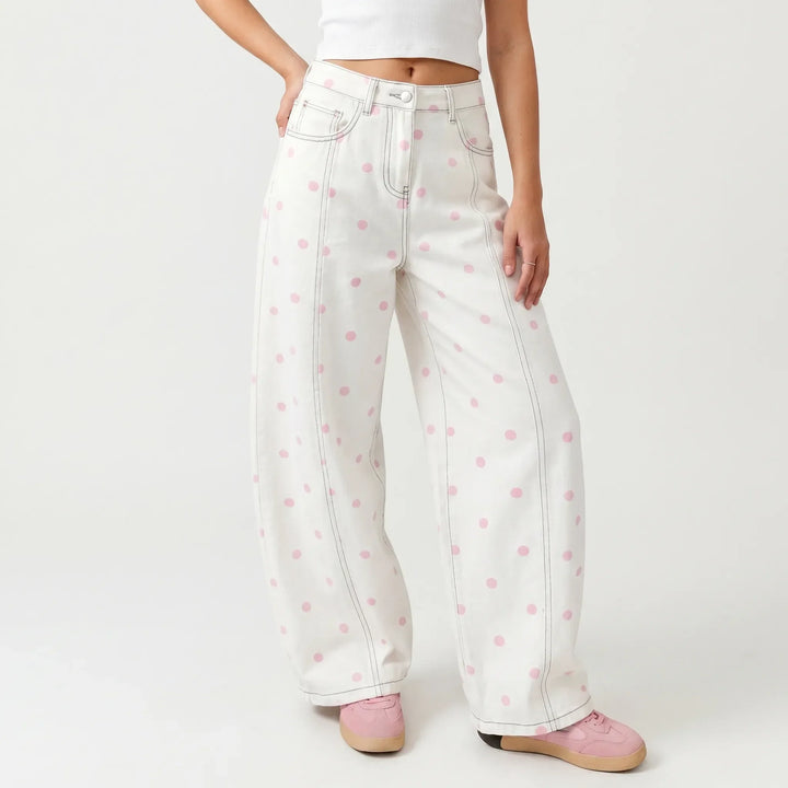 Women's relaxed fit high-waisted polka dot barrel pants with stylish button fly detail.