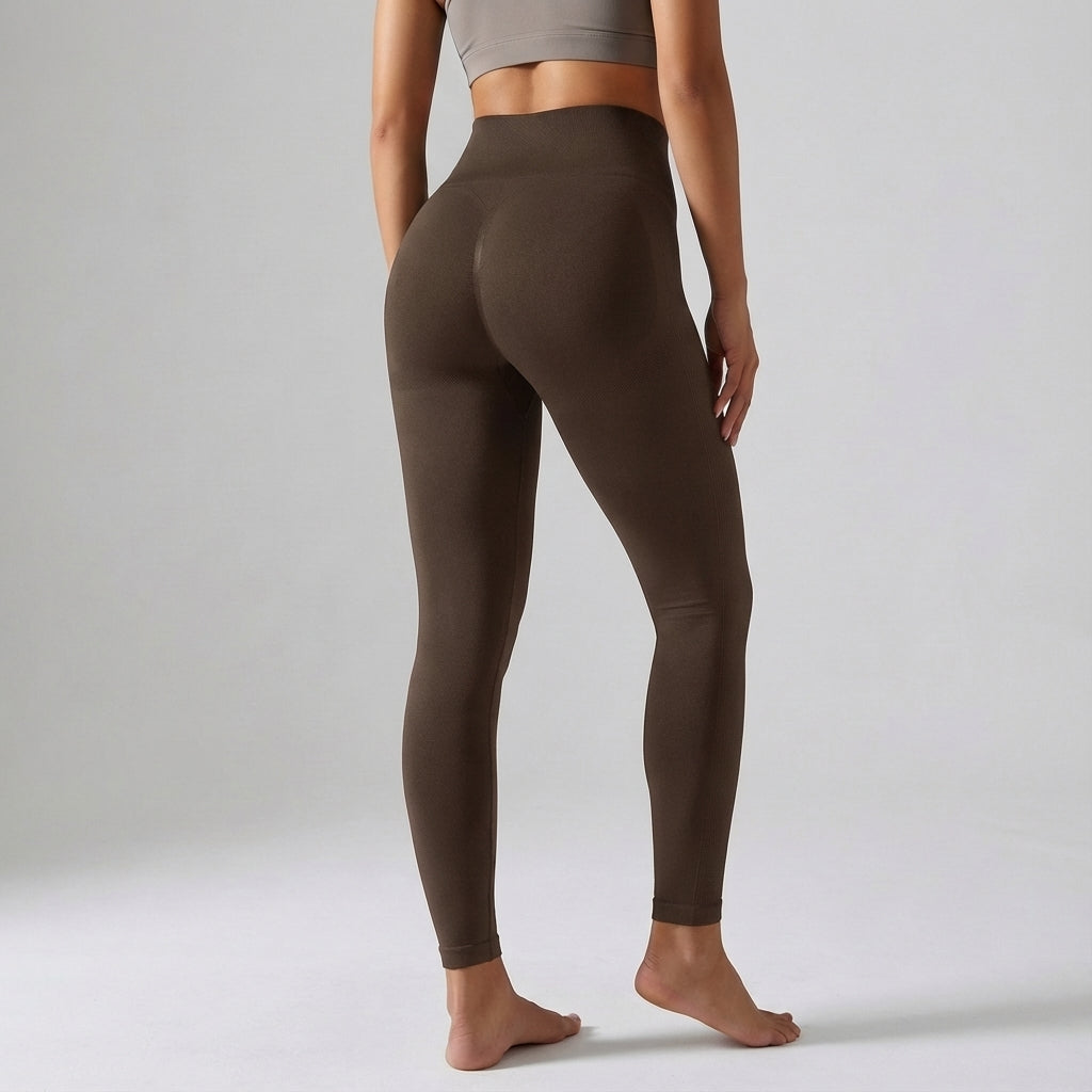 Woman wearing Janet high-waisted compression leggings, demonstrating their sculpting fit