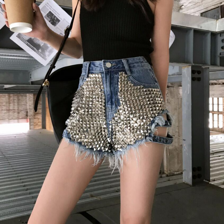 Casual women's high-waisted studded cutoffs with frayed hem, perfect for summer fashion & rebel street style.