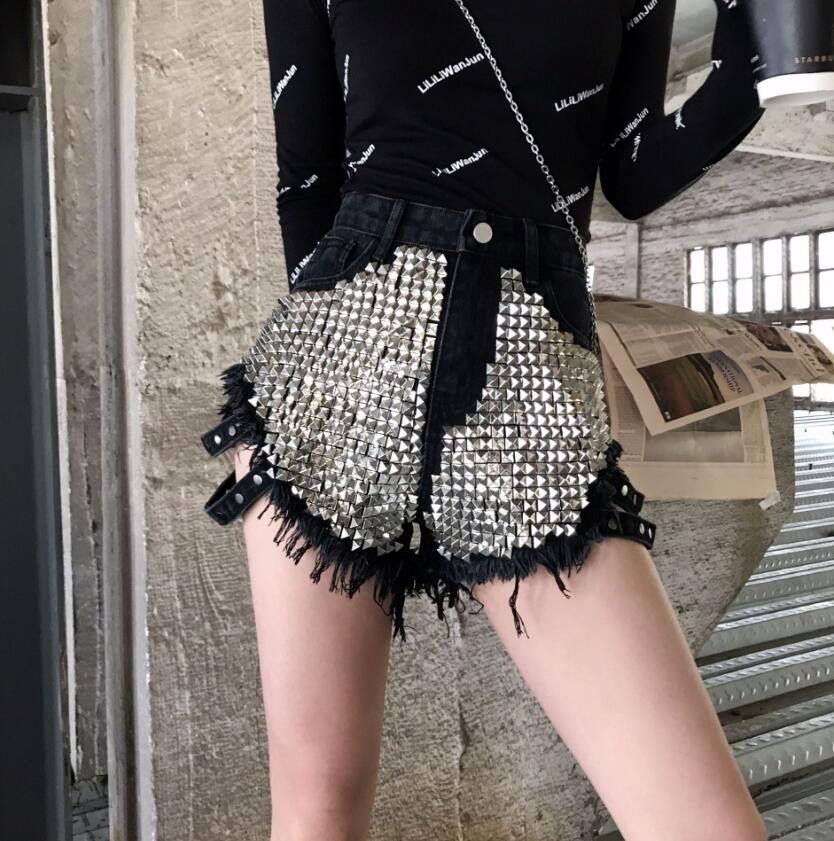 Edgy ladies' high-waisted denim shorts, featuring decorative silver studs & a stylish frayed hem. Summer ready.