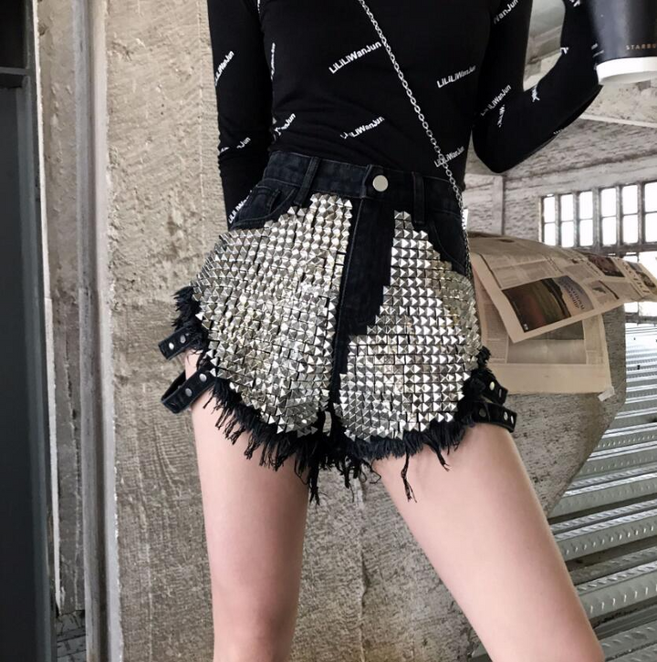 Edgy ladies' high-waisted denim shorts, featuring decorative silver studs & a stylish frayed hem. Summer ready.