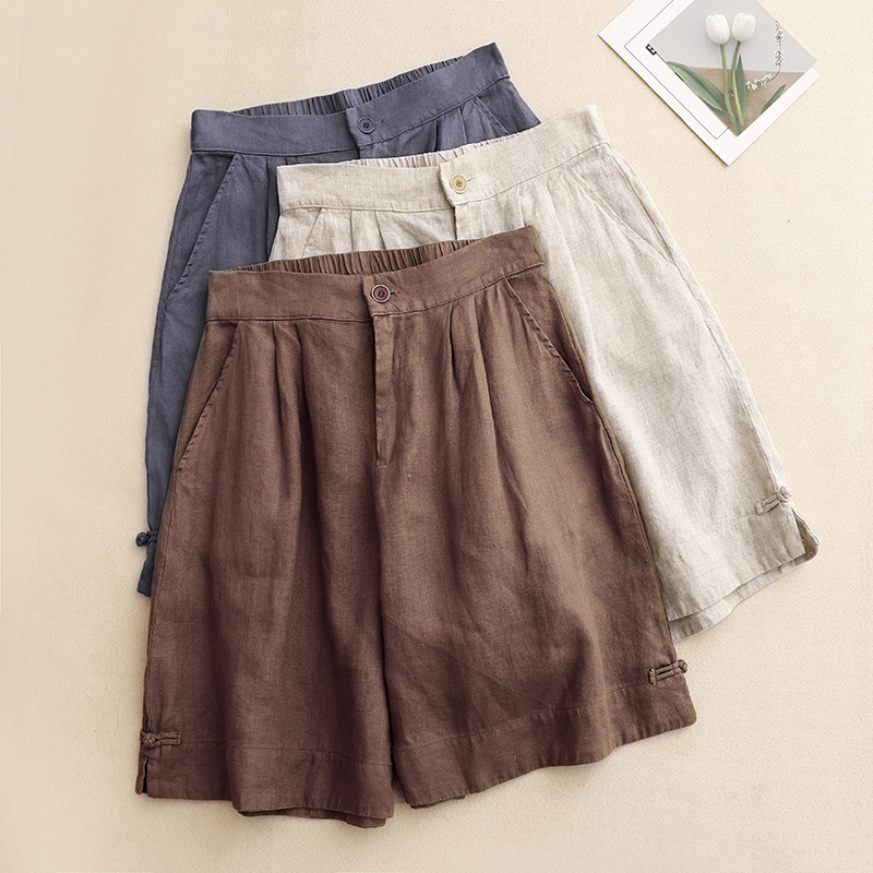 Fashionable high-waisted flowy shorts for women, featuring elegant pleats, perfect for warm weather.