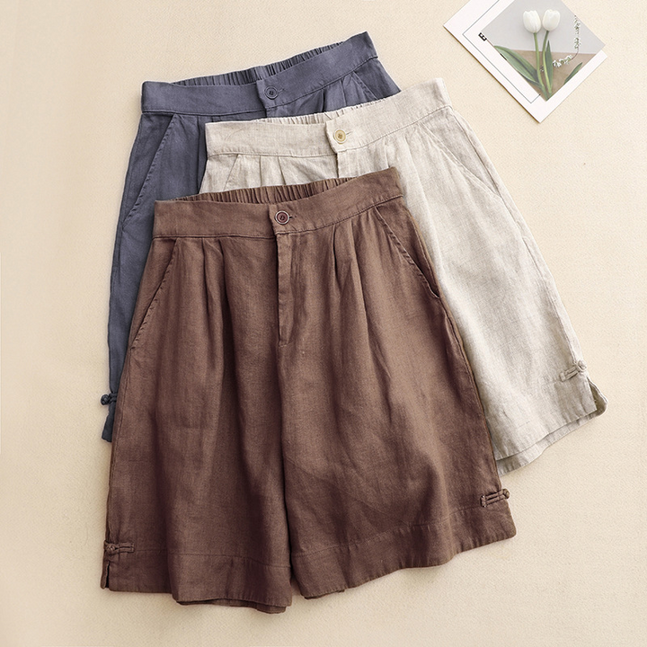 Fashionable high-waisted flowy shorts for women, featuring elegant pleats, perfect for warm weather.