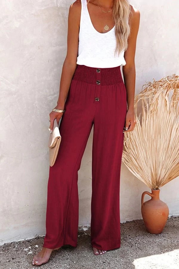 Stylish women's high-waisted trousers, featuring a smocked waist and elegant button detail for fashion.