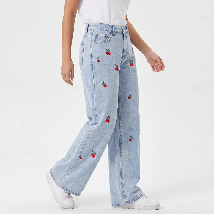 Stylish women's wide-leg jeans featuring a flattering high-waist and unique cherry embroidery, light wash denim.
