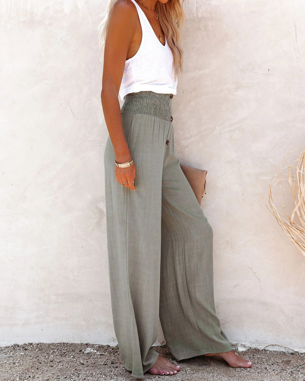 Detail of the high waist and wide leg cut of women's linen summer pants
