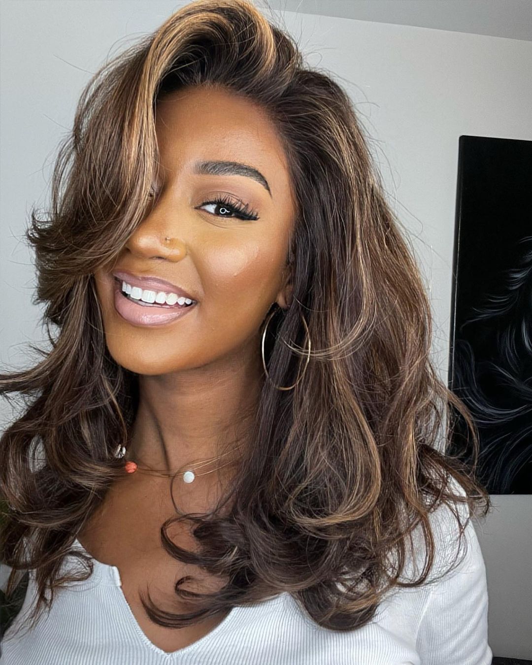 Women's Highlighted Human Hair Lace Front Wig with natural dark brown & blonde streaks, voluminous wavy style.