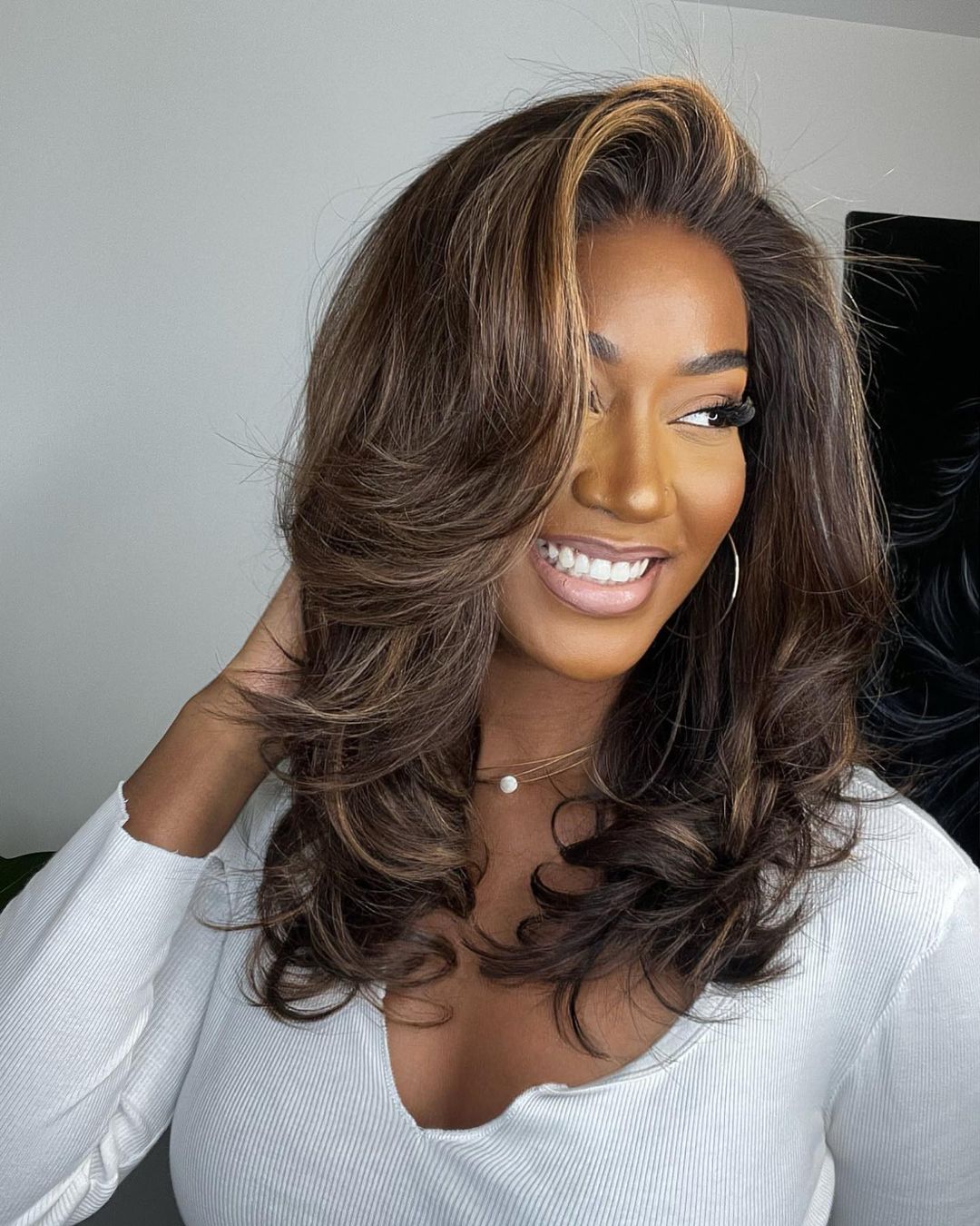 Natural looking lace front wig for women, featuring dark brown human hair with beautiful blonde highlights & waves.